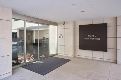 a lobby of a hotel with a sign on the wall at Villa Fontaine Tokyo Hatchobori in Tokyo
