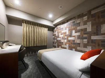 a hotel room with a bed and a desk at Villa Fontaine Tokyo Hatchobori in Tokyo