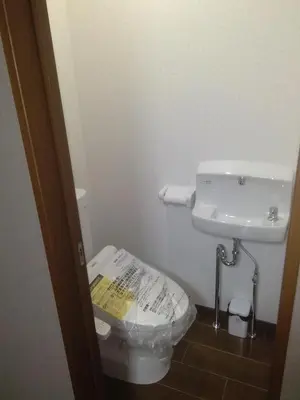 a bathroom with a toilet and a sink at Nice Hostel Yahiro in Tokyo