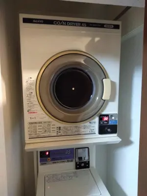 a washer and dryer in a room at Nice Hostel Yahiro in Tokyo