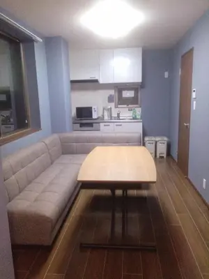 a living room with a couch and a table at Nice Hostel Yahiro in Tokyo