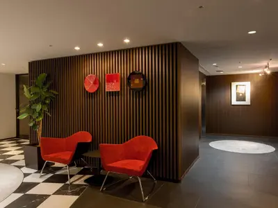 a meeting room with red chairs and a table at Shinagawa Tobu Hotel in Tokyo