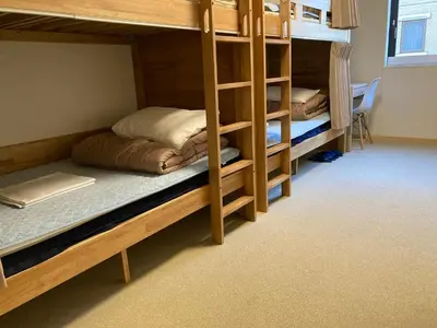 a room with two bunk beds and a desk at Tokyo Ueno Youth Hostel in Tokyo