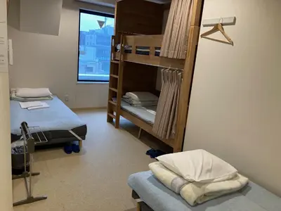 a room with two bunk beds and a window at Tokyo Ueno Youth Hostel in Tokyo
