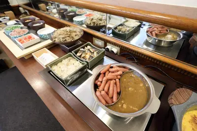 a buffet with different types of food on a table at Smile Hotel Nihombashi Mitsukoshimae in Tokyo