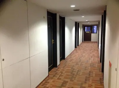 an empty hallway with black and white walls and a floor at Smile Hotel Nihombashi Mitsukoshimae in Tokyo