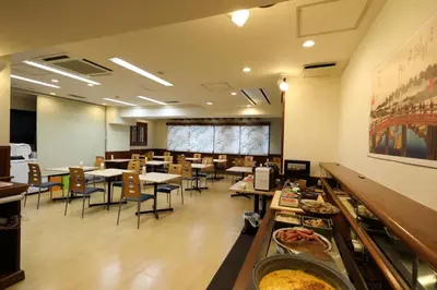 a restaurant with tables and chairs and a buffet at Smile Hotel Nihombashi Mitsukoshimae in Tokyo