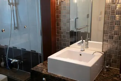 a bathroom with a white sink and a shower at HOTEL APERTO (Adult Only) in Tokyo