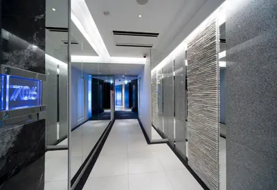 a hallway in a building with glass walls at HOTEL APERTO (Adult Only) in Tokyo