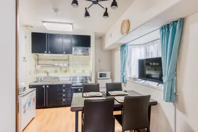 a kitchen with a table and chairs in a room at Park Residence Omori in Tokyo