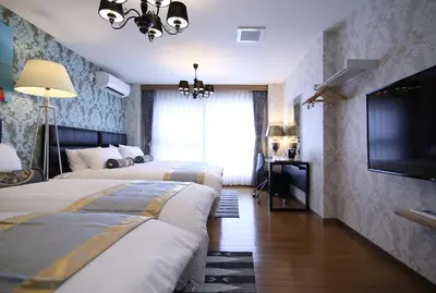 a hotel room with two beds and a flat screen tv at SHINJUKU GLOBAL HOTEL in Tokyo
