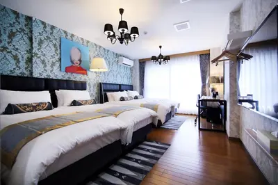 a hotel room with two beds and a television at SHINJUKU GLOBAL HOTEL in Tokyo