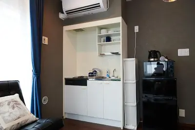 a small kitchen with a refrigerator in a room at Ueno Residence Hotel Matsumoto in Tokyo