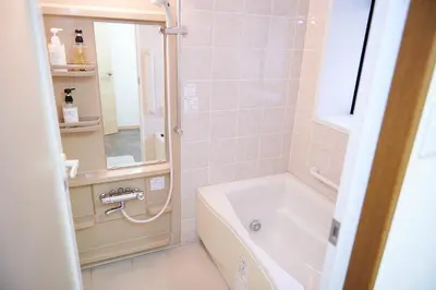 a bathroom with a shower and a tub and a sink at Ueno Residence Hotel Matsumoto in Tokyo