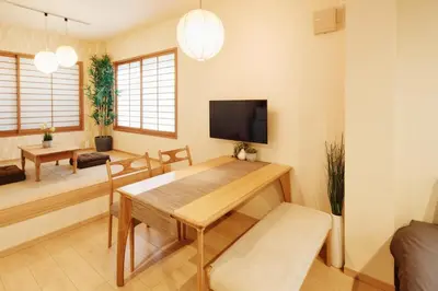 a living room with a table and a tv at Ueno Residence Hotel Matsumoto in Tokyo