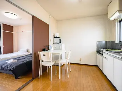 a room with a bed and a table and chairs at Murata Corpo 301 in Tokyo