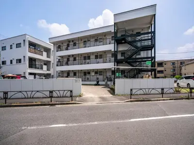 an apartment building with a spiral staircase in front of a street at Murata Corpo 301 in Tokyo