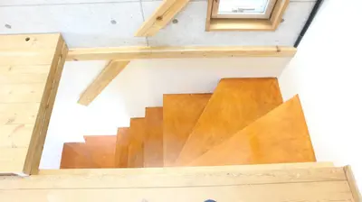 a wooden staircase in a tiny house at Kanamechō detached house in Tokyo