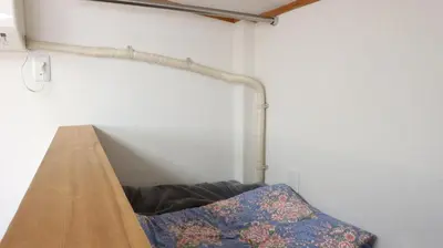 a wooden shelf in a room with a pillow at Kanamechō detached house in Tokyo