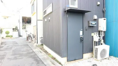 a blue door on the side of a building at Kanamechō detached house in Tokyo