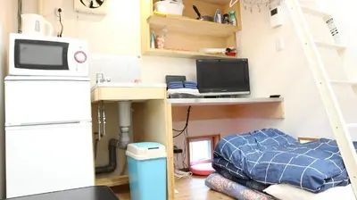 a room with a desk with a computer and a bed at Kanamechō detached house in Tokyo