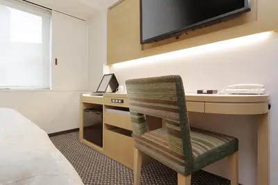 a room with a desk with a computer and a chair at Keio Presso Inn Nihonbashi Kayabacho in Tokyo