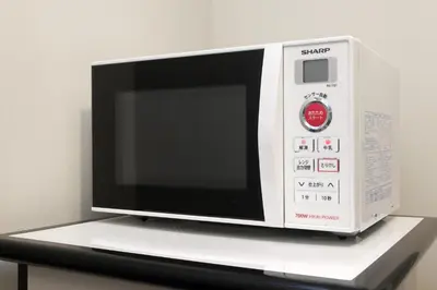 a microwave oven sitting on top of a shelf at Keio Presso Inn Nihonbashi Kayabacho in Tokyo