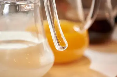 a close up of a glass jug of orange juice at Keio Presso Inn Nihonbashi Kayabacho in Tokyo