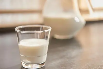 a glass of milk sitting on a table at Keio Presso Inn Nihonbashi Kayabacho in Tokyo