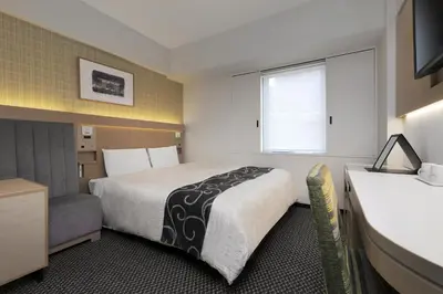 a hotel room with a large bed and a window at Keio Presso Inn Nihonbashi Kayabacho in Tokyo