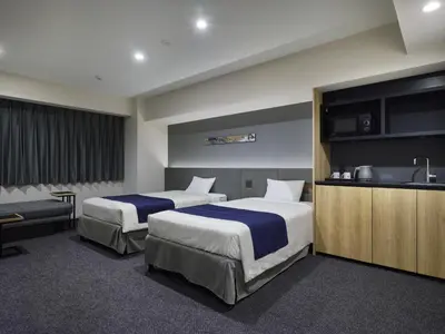 a hotel room with two beds and a kitchen at hotel MONday Akihabara Asakusabashi in Tokyo