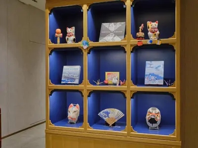 a shelf filled with figurines of cats and umbrellas at hotel MONday Akihabara Asakusabashi in Tokyo