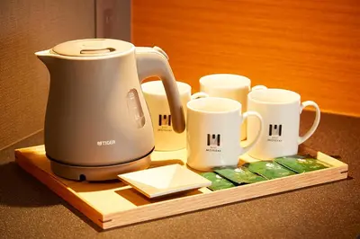 a coffee maker and cups on a wooden tray at hotel MONday Asakusa in Tokyo
