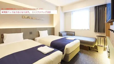 a hotel room with two beds and a window at hotel MONday Premium Ueno Okachimachi in Tokyo