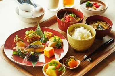 a tray with plates of food on a table at hotel MONday Premium Ueno Okachimachi in Tokyo