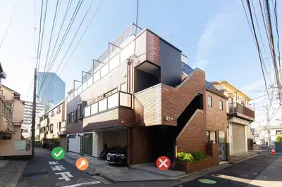 a brick building with a spiral staircase on a street at Cross Bridge Ikebukuro in Tokyo