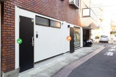 a white door on the side of a building at Cross Bridge Ikebukuro in Tokyo