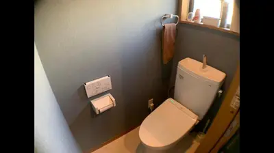 a bathroom with a toilet and a towel on the wall at Hotel EL Shinjuku 2 in Tokyo