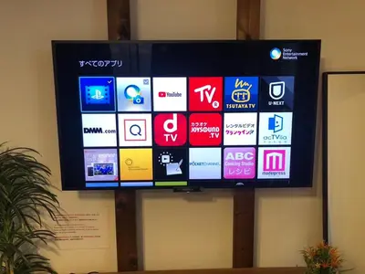 a flat screen tv on a wall with different apps at Hotel EL Shinjuku 2 in Tokyo