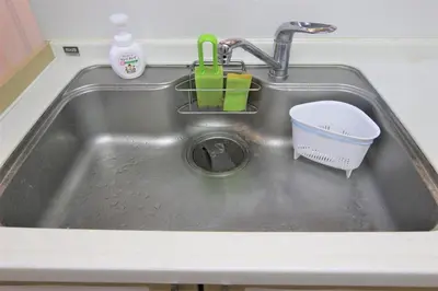 a kitchen sink with a dish basket in it at Hotel EL Shinjuku 2 in Tokyo