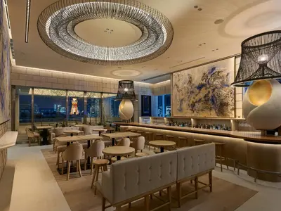 a restaurant with tables and chairs and a large chandelier at Mitsui Garden Hotel Roppongi Tokyo Premier in Tokyo