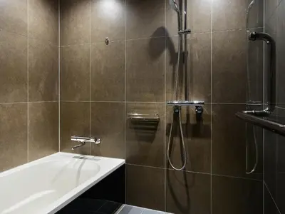 a bathroom with a shower and a tub and a sink at Mitsui Garden Hotel Roppongi Tokyo Premier in Tokyo
