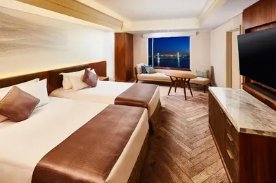 a hotel room with two beds and a flat screen tv at InterContinental Tokyo Bay by IHG in Tokyo