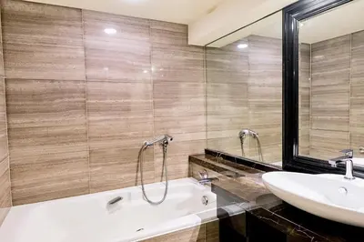 a bathroom with a white tub and a sink at InterContinental Tokyo Bay by IHG in Tokyo