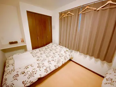 a small bedroom with a bed and a window at Hotel EL Shinjuku 1 free parking in Tokyo