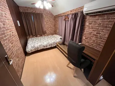 a small room with a bed in a brick wall at Hotel EL Shinjuku 1 free parking in Tokyo
