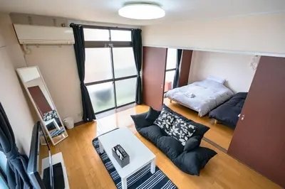 a small room with a bed and a couch at Murata Corpo / Vacation STAY 4497 in Tokyo