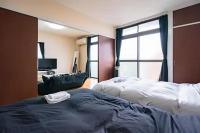 a hotel room with two beds and a large window at Murata Corpo / Vacation STAY 4497 in Tokyo