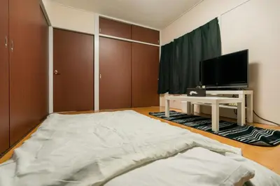 a living room with a large bed and a tv at Murata Corpo / Vacation STAY 4497 in Tokyo