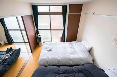 a bedroom with a bed and a large window at Murata Corpo / Vacation STAY 4497 in Tokyo